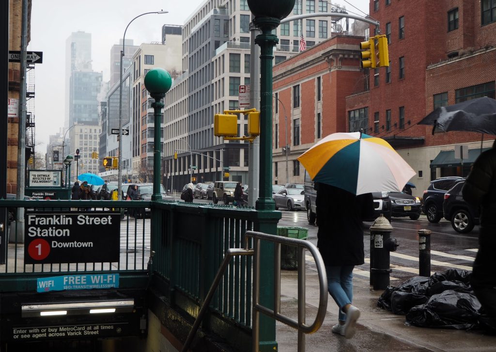 a person walking down a street holding an umbrella